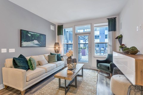 a living room with a couch and a fireplace and glass doors